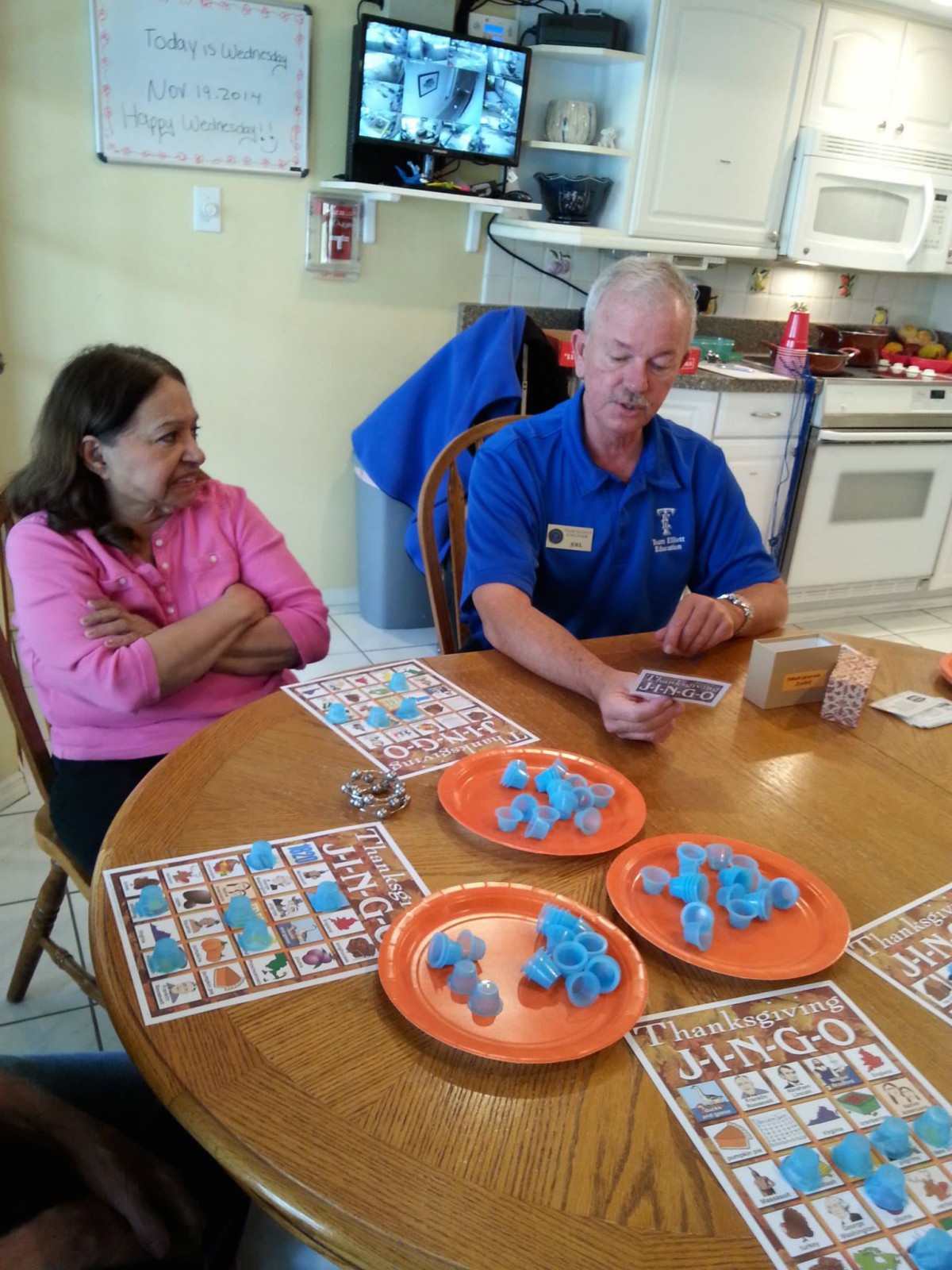 Two people playing bingo at a table indoors.