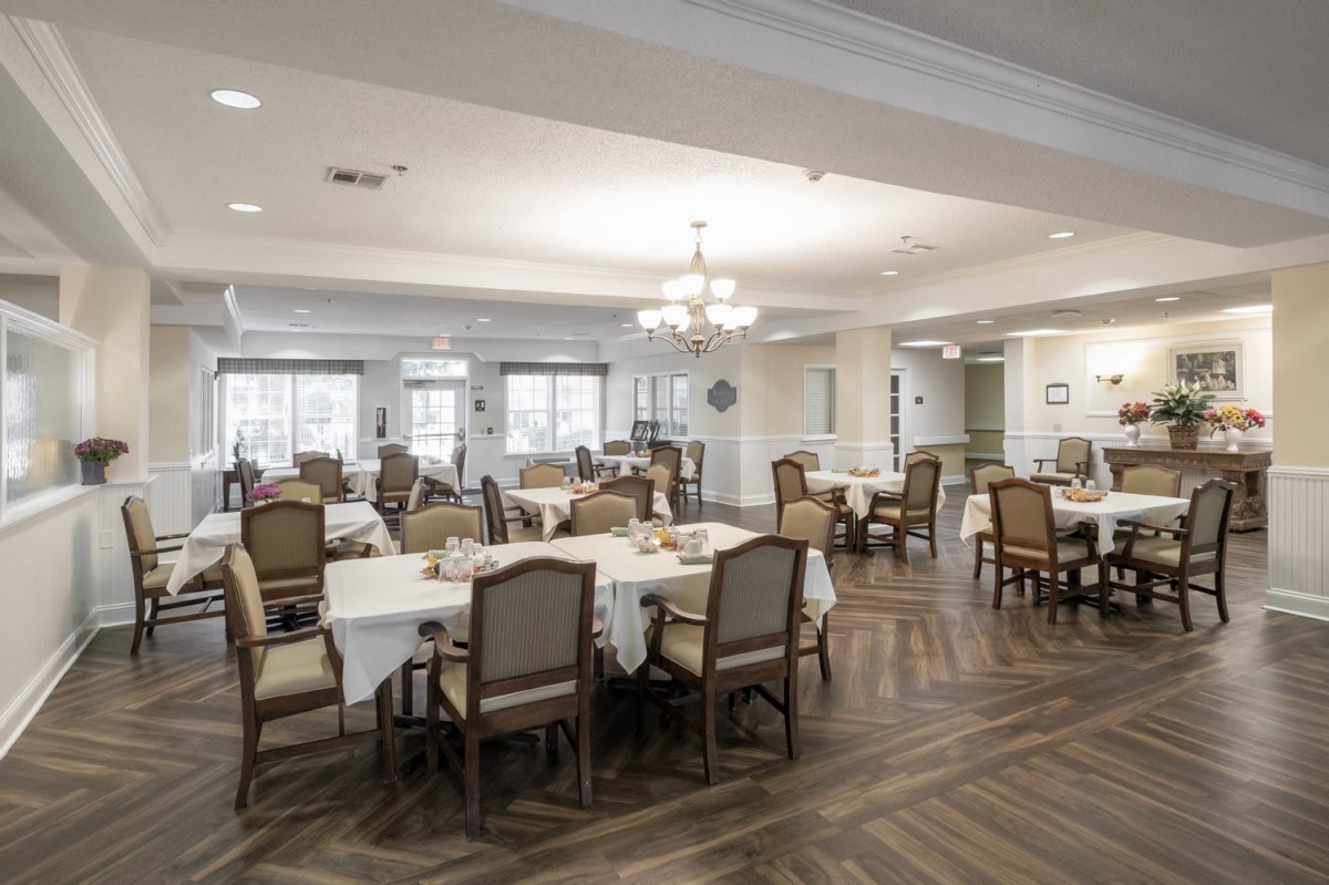 Spacious and elegantly decorated dining area with neatly arranged tables and chairs.
