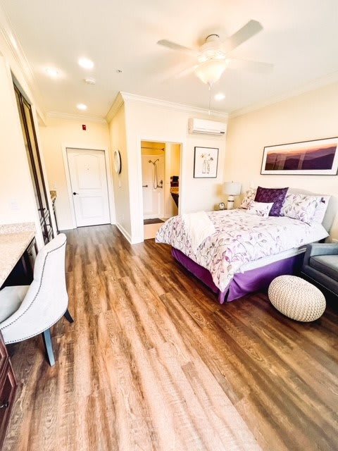 A modern bedroom with stylish decor and wood flooring.