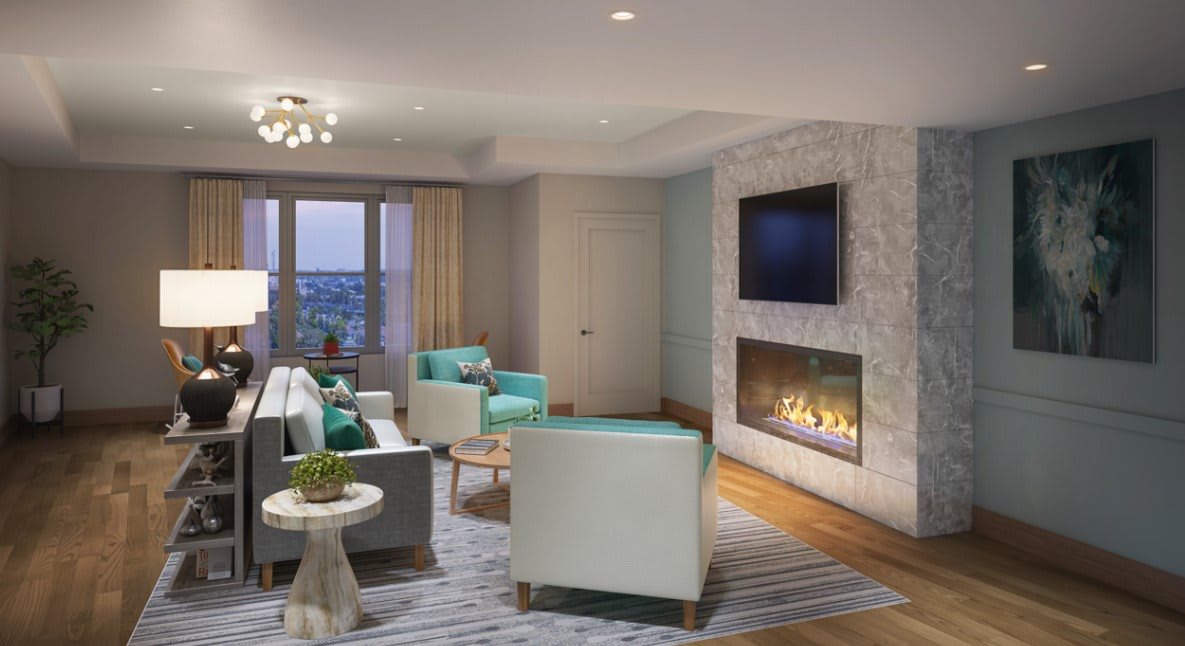 A modern living room featuring a fireplace, television, and a stylish seating area with a window view.