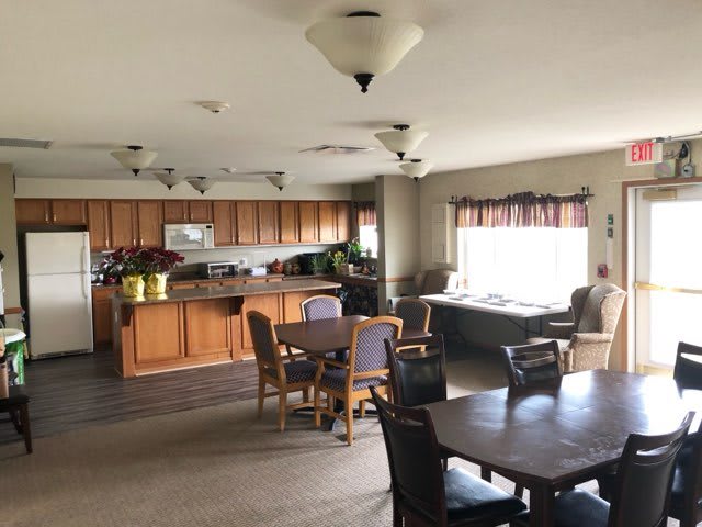 A spacious kitchen and dining area with wooden furniture and ample lighting.