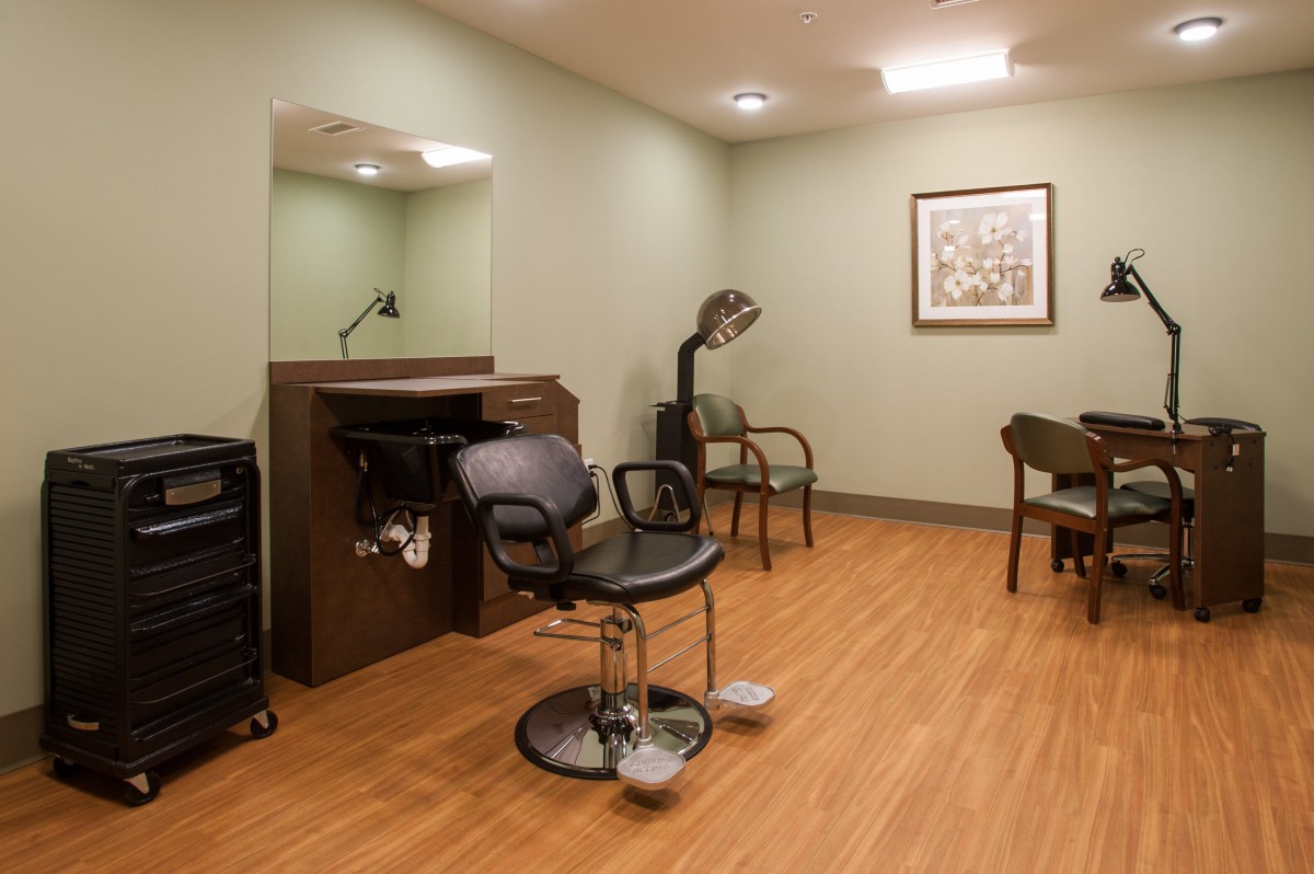 A cozy salon setup featuring a hairdressing chair, mirror, and essential equipment.