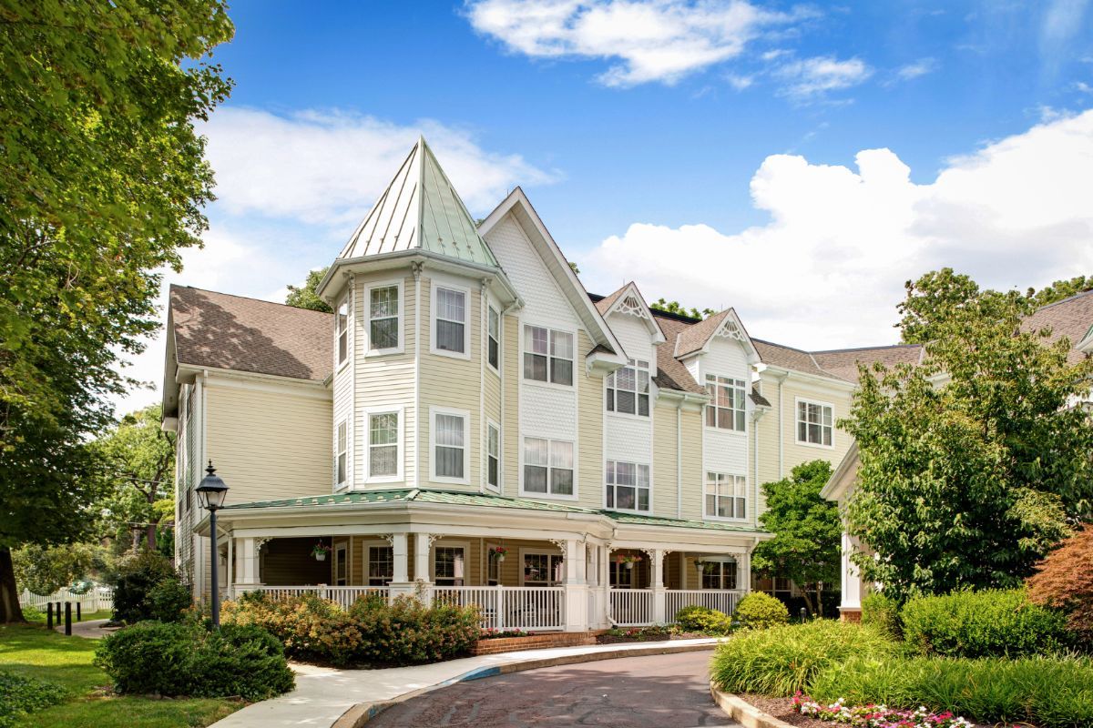 A picturesque residential building under a blue sky with clouds.