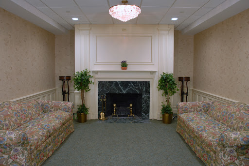 Cozy living room setting featuring a fireplace and comfortable sofas.