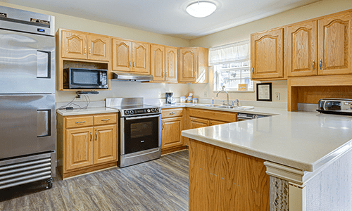 A modern kitchen with wooden cabinets and stainless steel appliances.