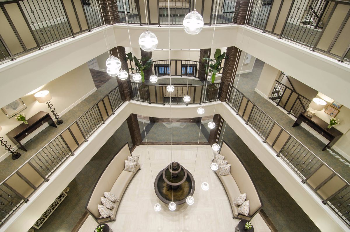 A modern atrium with bright lighting and elegant furnishings in a multi-story lobby.