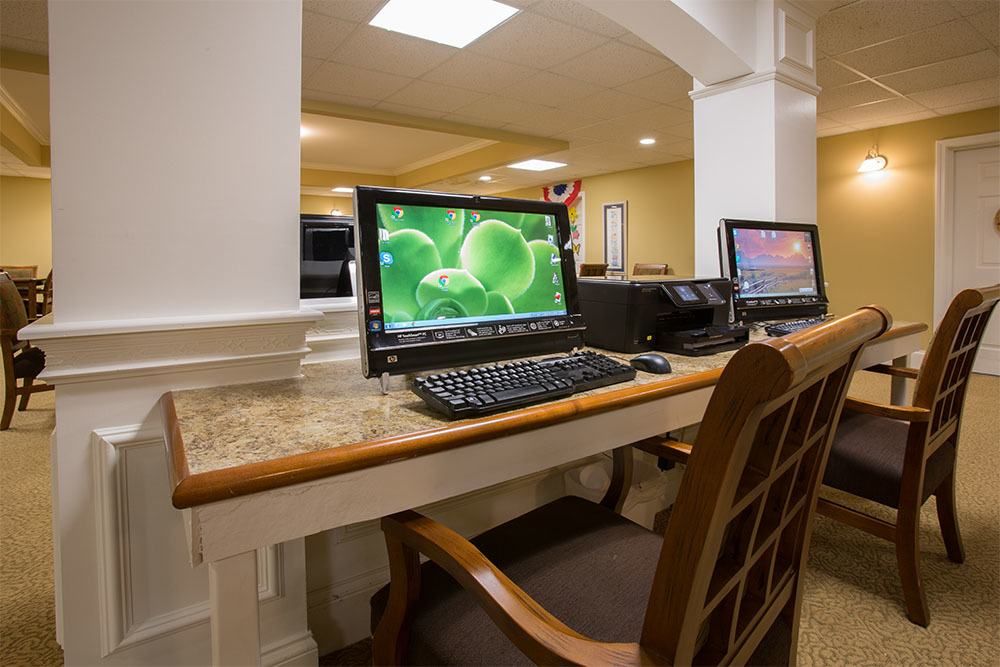 A modern office workstation with computers on a desk.