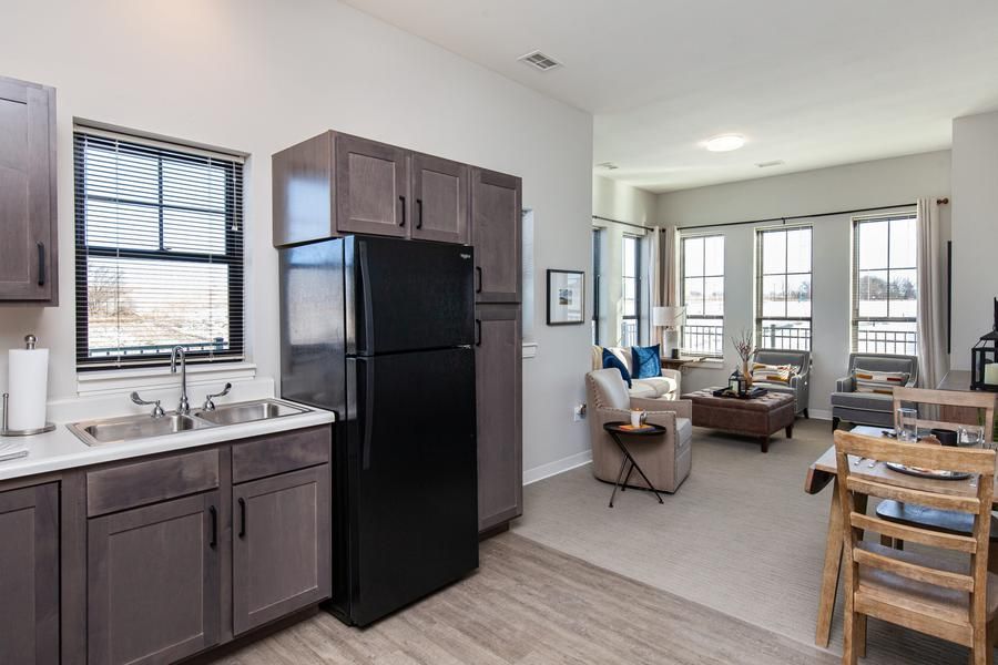 A modern apartment interior featuring an open space with a kitchen and living room.