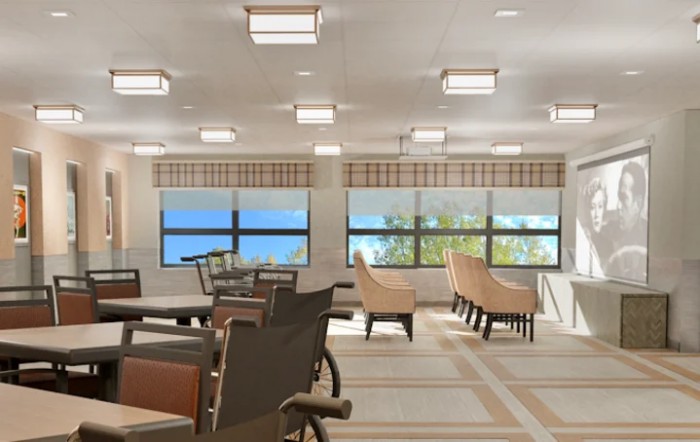 A bright and spacious interior seating area with tables and chairs beside large windows.