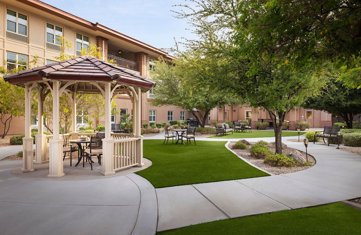 A peaceful courtyard with a gazebo and outdoor seating surrounded by well-maintained landscaping.
