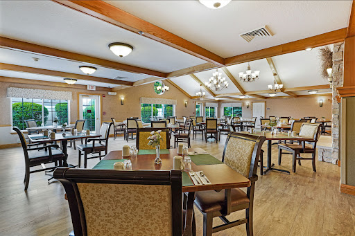 A spacious dining room set up for meals, featuring well-arranged tables and comfortable seating.