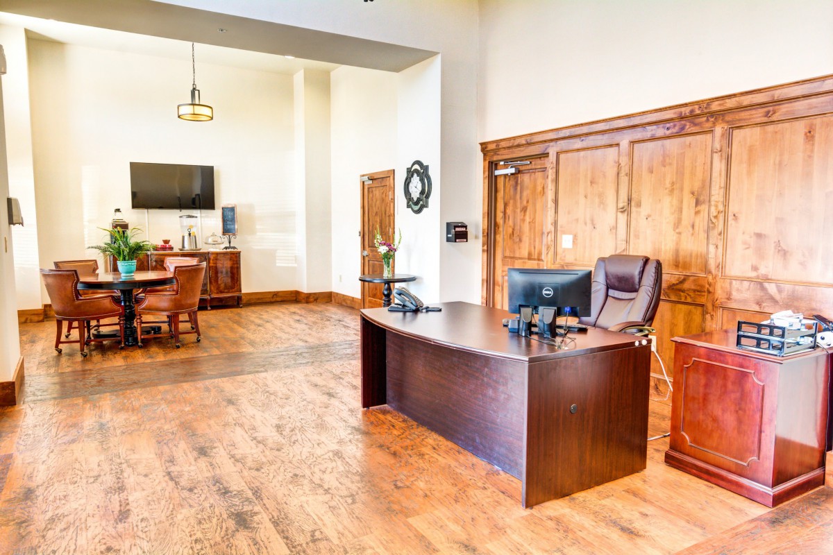 A spacious office space with a desk and meeting area.