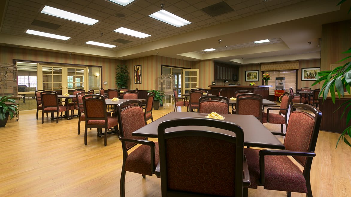 An empty dining area with neatly arranged tables and chairs.