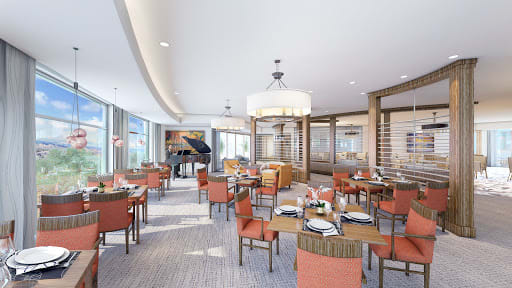 A well-lit, elegant dining area featuring multiple tables and comfortable seating.