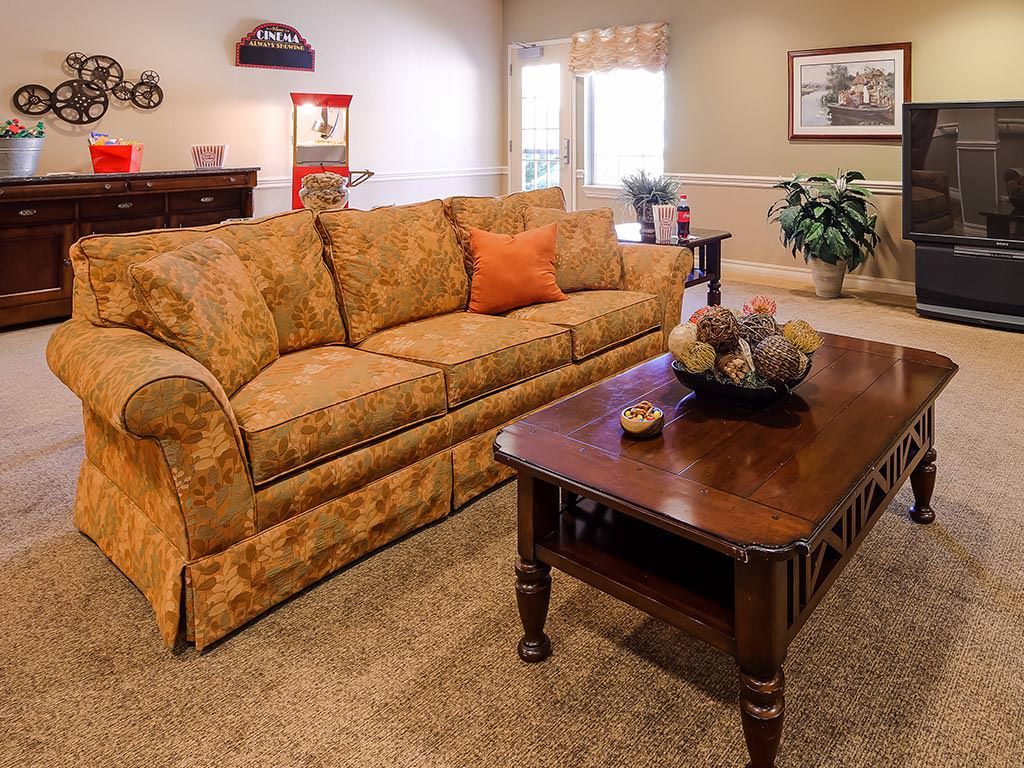 A cozy living room with a patterned sofa and wooden coffee table.