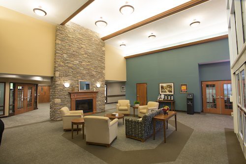 A modern lobby area featuring comfortable seating and a fireplace.