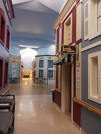 A vibrant interior corridor designed to resemble a quaint street scene.