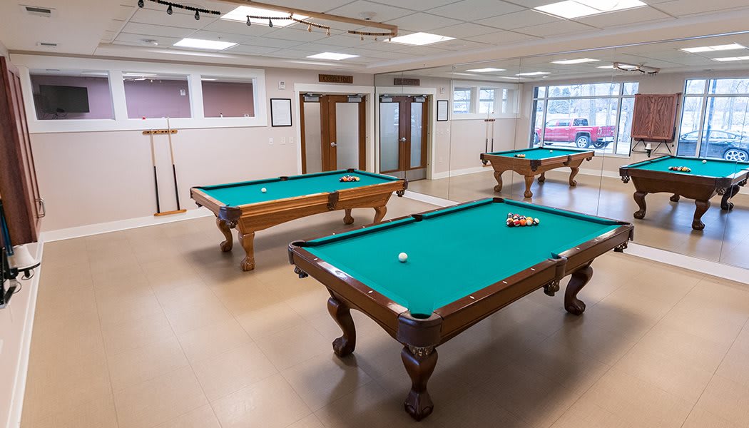 A spacious game room featuring multiple pool tables for recreational play.