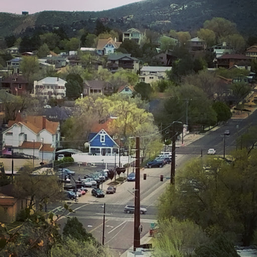 A view of a small town nestled among hills, showcasing residential buildings and streets.