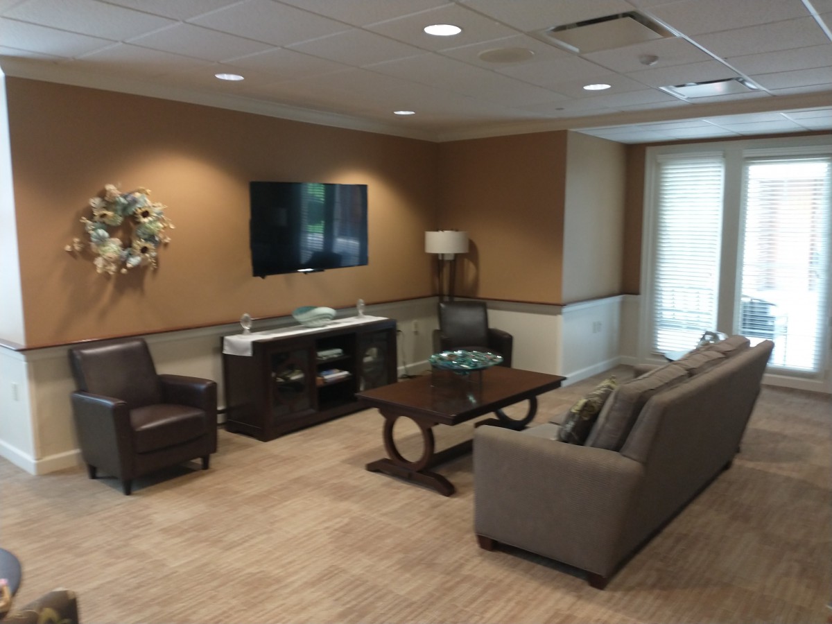 A modern living room with comfortable seating, a coffee table, and a mounted television.