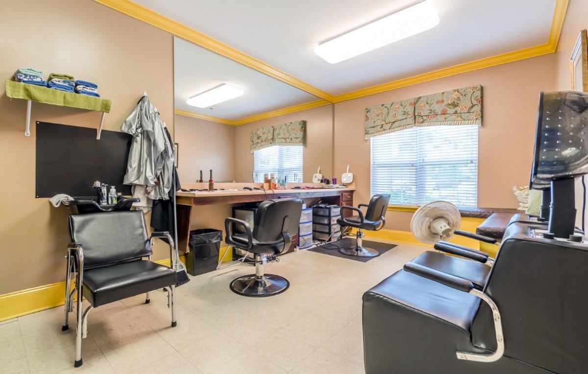 A well-lit hair salon with multiple chairs and mirrors, creating a comfortable workspace.