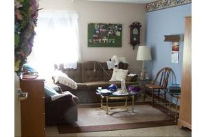 A cozy living room area with a sofa, coffee table, and decorative elements.