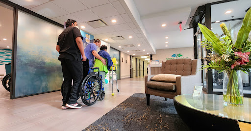 Caregivers assisting a patient in a healthcare facility.