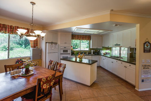 A spacious and well-lit kitchen featuring modern design elements and a cozy dining area.