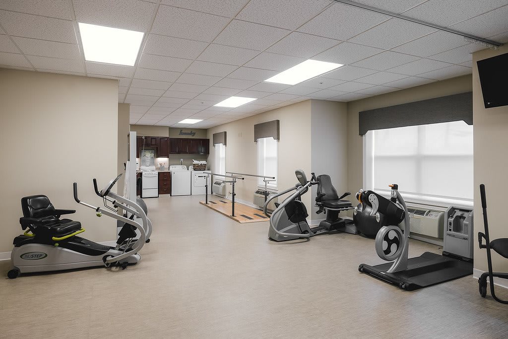 A well-equipped gym with various exercise machines and a modern interior.