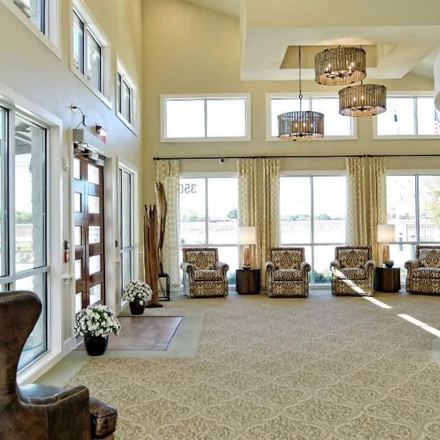 A bright and modern lobby area with ample seating and large windows.