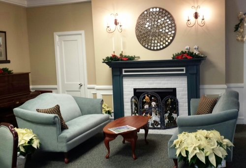 A cozy living room with a stylish fireplace and comfortable seating.