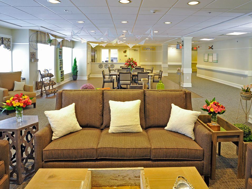 A cozy living room with a brown sofa and decorative pillows.
