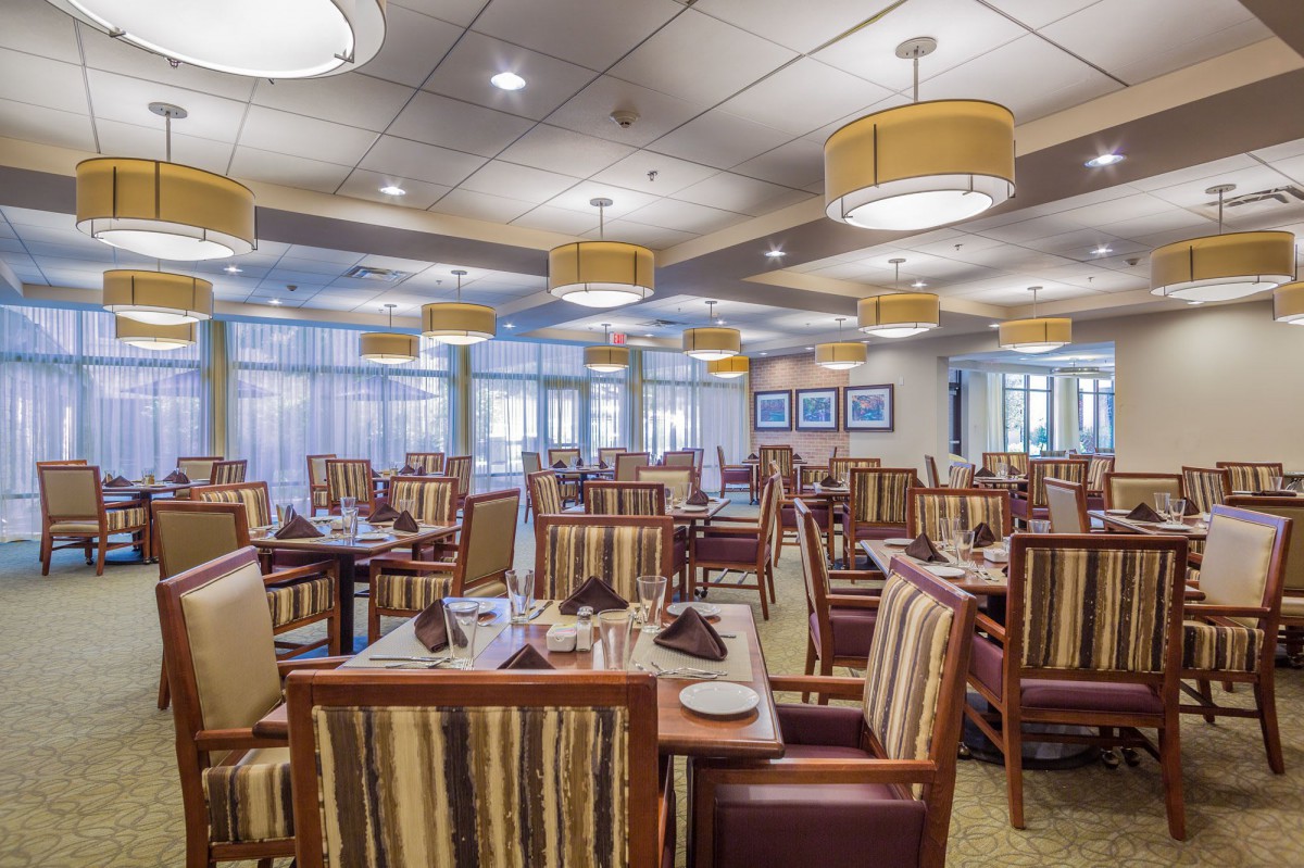 An elegant restaurant interior with neatly arranged tables and chairs.
