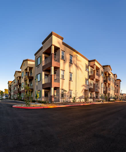Modern apartment complex under a clear blue sky.