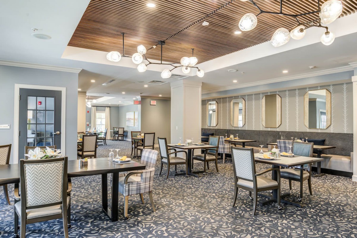 A stylish modern dining area with elegant tables, chairs, and contemporary lighting.