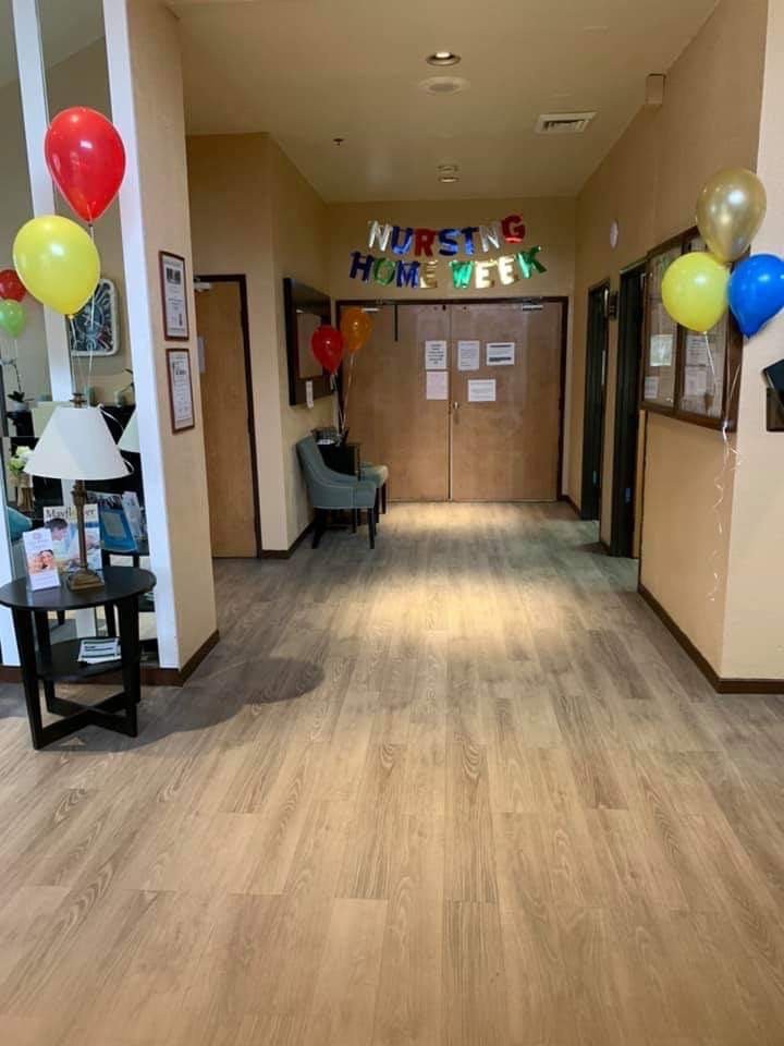 A decorated hallway with colorful balloons and a welcome banner.