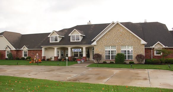 A suburban house with a brick exterior and a well-kept lawn.