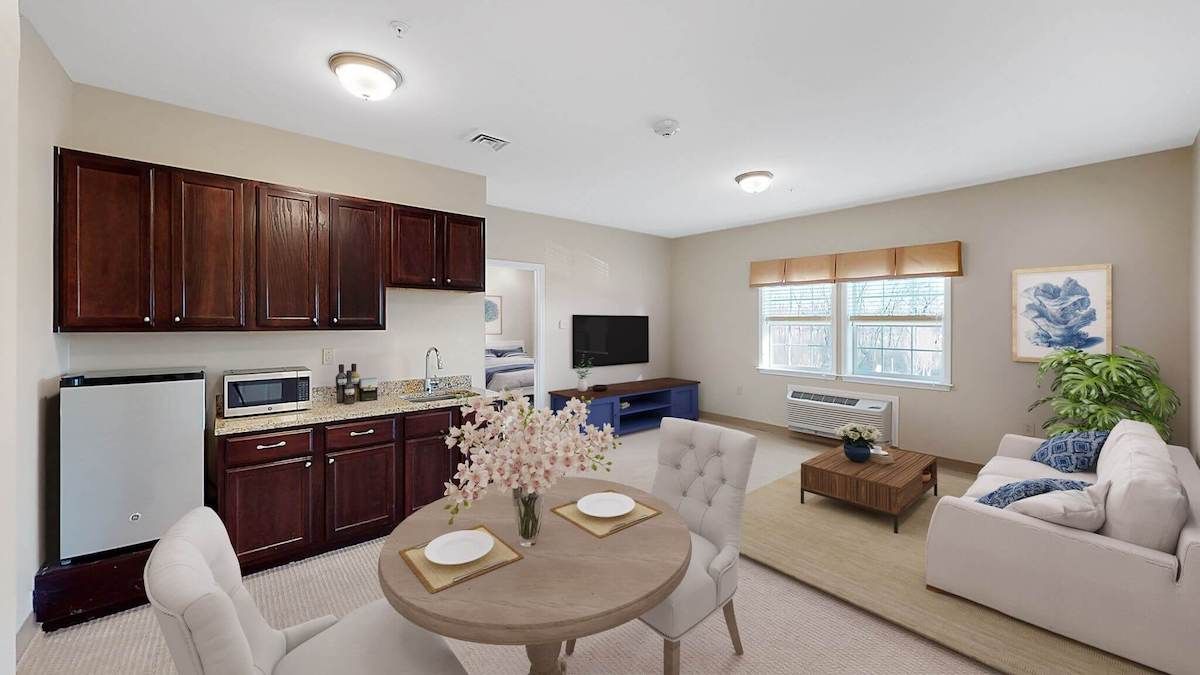 A cozy open-plan living space featuring a kitchen, dining area, and living room.