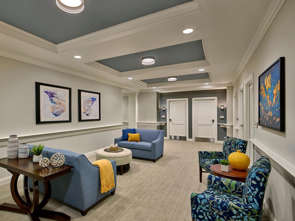 A modern waiting room with comfortable seating and elegant decor.