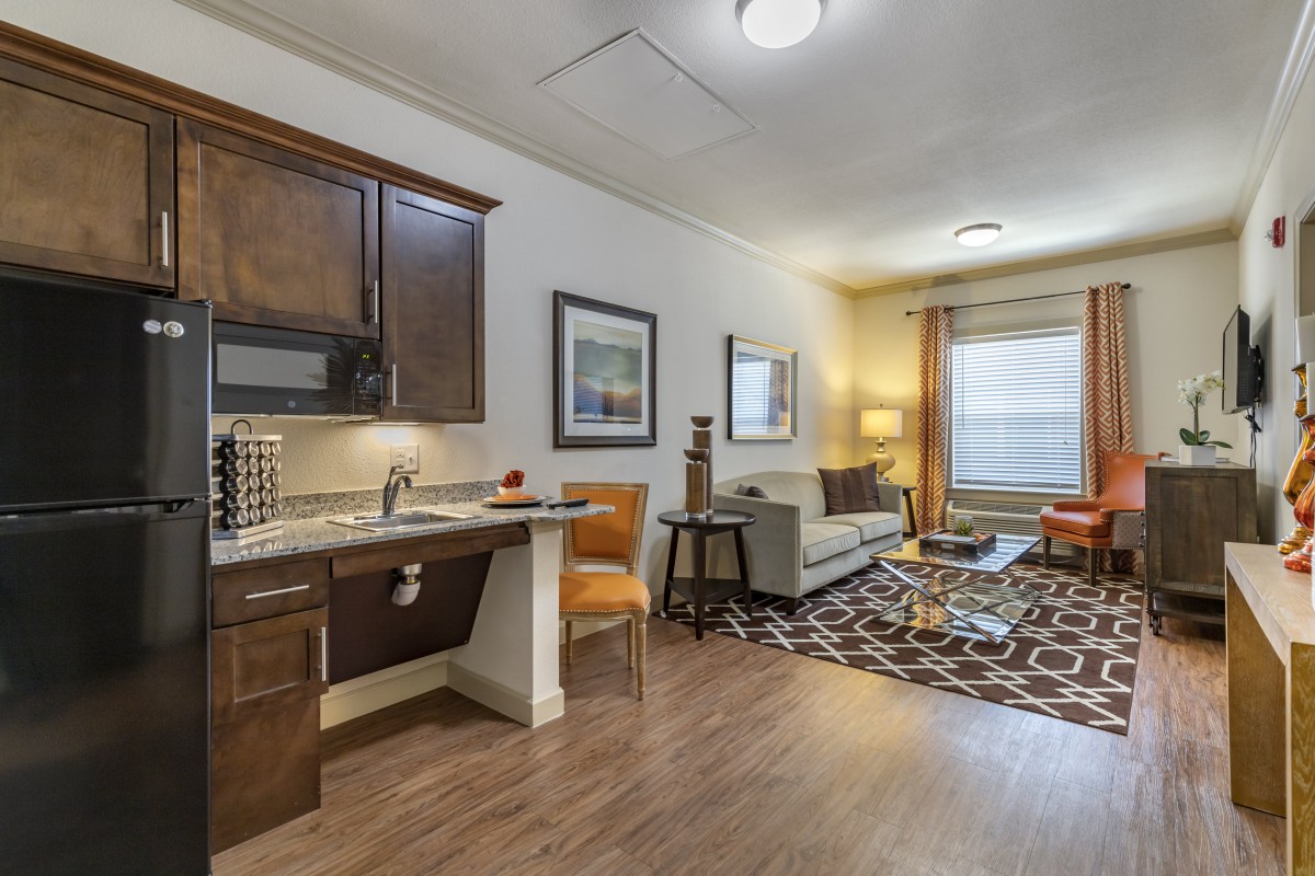 A modern living space with a kitchenette and stylish furnishings.