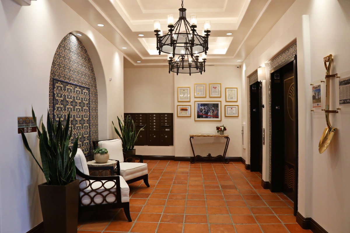 A stylish lobby with elegant lighting, comfortable seating, and decorative elements.