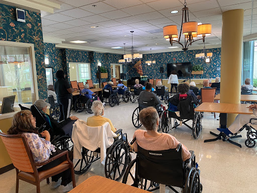 Residents of a nursing home participating in an activity in the common area.