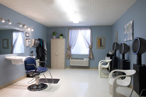A cozy salon interior featuring blue walls and modern furniture.