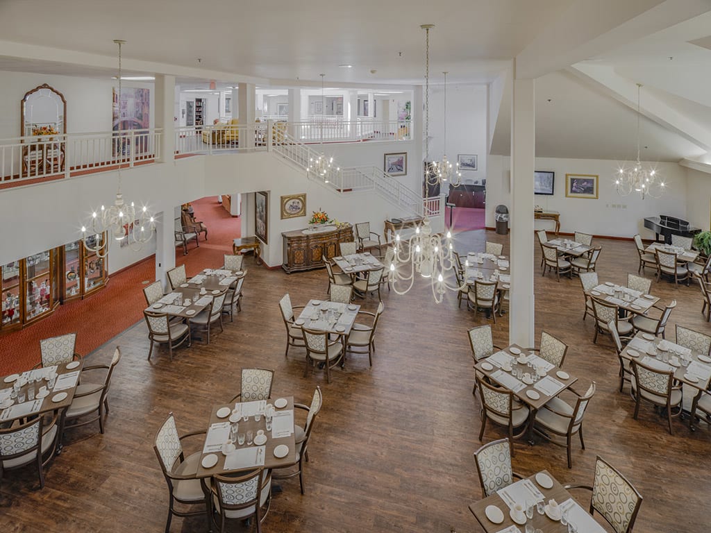 An elegant restaurant dining area with arranged tables and chandeliers.