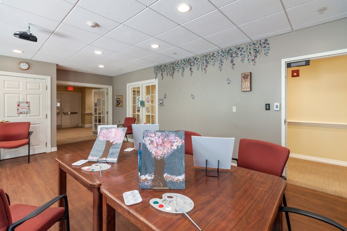 A communal dining area with decorated tables and chairs in a well-lit room.