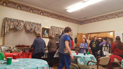 A group of people enjoying a gathering in a cozy indoor setting.