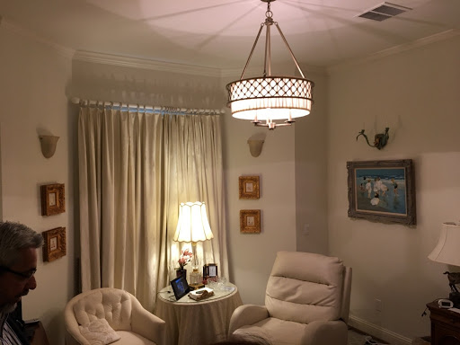 A cozy living room featuring soft lighting, comfortable seating, and elegant decor.