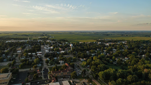 A serene aerial view of a small town nestled in the countryside during sunset.