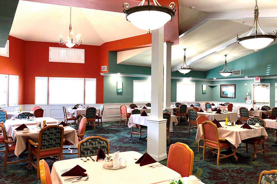 A well-lit restaurant interior with neatly arranged dining tables and colorful decor.