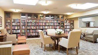 A cozy library with comfortable seating and bookshelves filled with books.